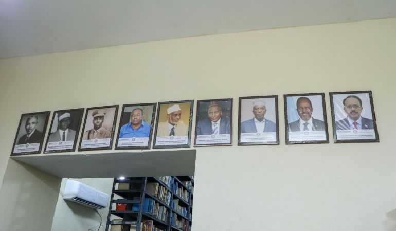 Portraits of Somalia's presidents line a wall at Radio Mogadishu. [Abdimajid Abdillahi Farah/Al Jazeera]