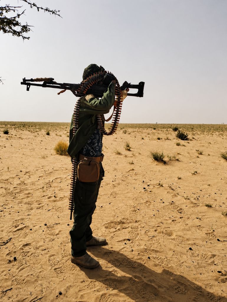 An armed man carries a weapon in a desert area of northern Mali, where government forces and armed groups have been fighting for control of territory [Photo: Courtesy of the Azawad Liberation Front (FLA)]